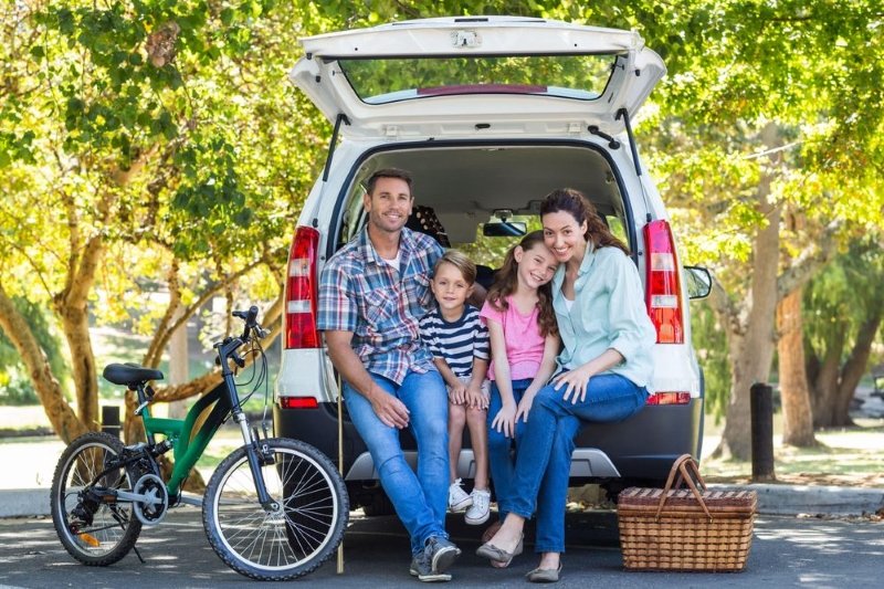 Happy family at the car